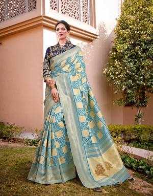 A checkered saree never goes out of fashion. Step out to your next festivity in this fresh blue silk weaved saree and look pleasing. 