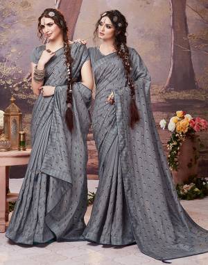 Here Is A Very Pretty Designer Saree In Grey Color For The Upcoming Festive Season. This Saree Is Fabricated On Soft Art Silk Paired With Art Silk Fabricated Blouse. It Is Beautified With Embroidered Buttis All Over. Buy Now.