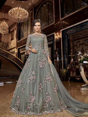 Flaunt Your Rich And Elegant Taste Wearing This Heavy Designer Floor Length Suit In Grey Color. Its Floor Length Top IS Net Based Beautified With Attractive Contrasting Embroidery Paired With Santoon Bottom And Net Fabricated Dupatta. 