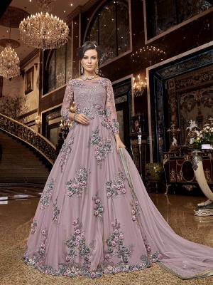 Flaunt Your Rich And Elegant Taste Wearing This Heavy Designer Floor Length Suit In Lilac Color. Its Floor Length Top IS Net Based Beautified With Attractive Contrasting Embroidery Paired With Santoon Bottom And Net Fabricated Dupatta. 