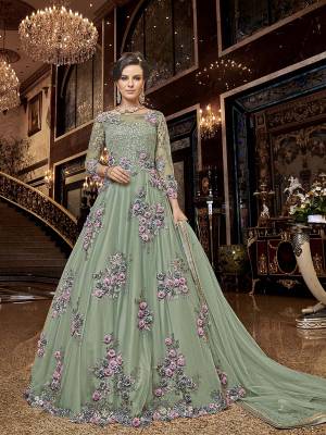 Flaunt Your Rich And Elegant Taste Wearing This Heavy Designer Floor Length Suit In Pastel Green Color. Its Floor Length Top IS Net Based Beautified With Attractive Contrasting Embroidery Paired With Santoon Bottom And Net Fabricated Dupatta. 