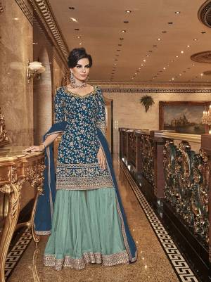 Bold And Elegant Color Pallete IS Here With This Designer Sharara Suit In Blue Colored Top And Dupatta Paired With Contrasting Sky Blue Colored Bottom. Its Top, Bottom And Dupatta Are Fabricated On Net Beautified With Heavy Embroidery. Buy Now.