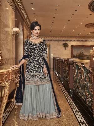 Bold And Elegant Color Pallete IS Here With This Designer Sharara Suit In Black Colored Top And Dupatta Paired With Contrasting Grey Colored Bottom. Its Top, Bottom And Dupatta Are Fabricated On Net Beautified With Heavy Embroidery. Buy Now.