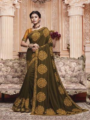 Get Ready For The Upcoming Wedding And Festive Season With This Designer Saree In Dark Olive Green Color Paired With Contrasting Musturd Yellow Colored Blouse. This Contrasting Embroidered Saree Is Fabricated On Vichitra Silk Paired With Art Silk Fabricated Blouse.