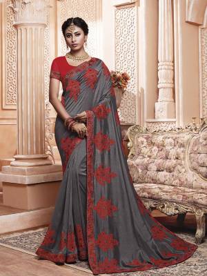 Get Ready For The Upcoming Wedding And Festive Season With This Designer Saree In Grey Color Paired With Contrasting Red Colored Blouse. This Contrasting Embroidered Saree Is Fabricated On Vichitra Silk Paired With Art Silk Fabricated Blouse.