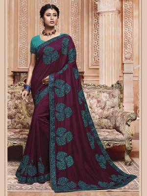 Get Ready For The Upcoming Wedding And Festive Season With This Designer Saree In Wine Color Paired With Contrasting Sky Blue Colored Blouse. This Contrasting Embroidered Saree Is Fabricated On Vichitra Silk Paired With Art Silk Fabricated Blouse.