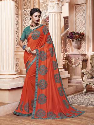 Get Ready For The Upcoming Wedding And Festive Season With This Designer Saree In Orange Color Paired With Contrasting Blue Colored Blouse. This Contrasting Embroidered Saree Is Fabricated On Vichitra Silk Paired With Art Silk Fabricated Blouse.
