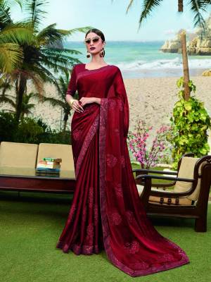 Catch All The Limelight Wearing This Bright And Appealing Designer Saree In Maroon Color. This Saree IS Chinon Based Paired With Art Silk Fabricated Blouse. Buy this Lovely Piece Now.