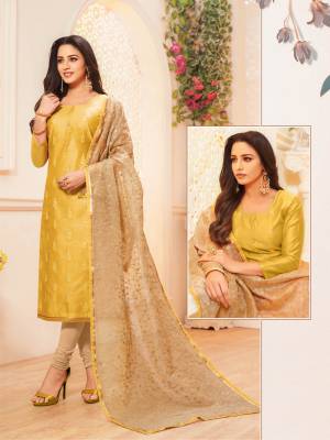 Grab This Pretty Designer Straight Suit To Your Wardrobe In Yellow Colored Top Paired With Beige Colored Bottom And Dupatta. This Pretty Top Is Fabricated On Modal Silk Paired With Cotton Bottom And Net Fabricated Dupatta. 