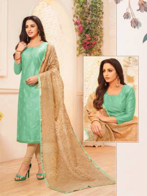 Grab This Pretty Designer Straight Suit To Your Wardrobe In Sea Green Colored Top Paired With Beige Colored Bottom And Dupatta. This Pretty Top Is Fabricated On Modal Silk Paired With Cotton Bottom And Net Fabricated Dupatta. 