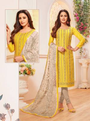 Simple And Elegant Looking Suit Here In Yellow Colored Top Paired With Grey Colored Bottom And Dupatta. Its Top Is Modal Silk Based Paired With Cotton Bottom And Orgenza Fabricated Embroidered Dupatta. Buy This Designer Straight Suit Now. 