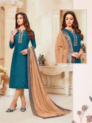 Here Is A Rich And Elegant Looking Designer Straight Suit In Blue Colored Top Paired With Beige Colored Bottom And Dupatta. Its Top Is Fabricated On Soft Silk Paired With Cotton Bottom And Modal Silk Dupatta. 