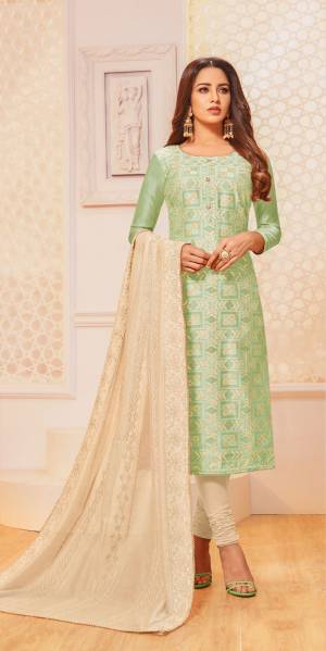 For Your Semi-Casual Wear, Grab This Pretty Semi-Stitched Suit In Light Green Colored Top Paired With Cream Colored Bottom And Dupatta. Its Top Is Fabricated On Jacquard Silk Paired With Cotton Bottom And Chanderi Silk Dupatta. 