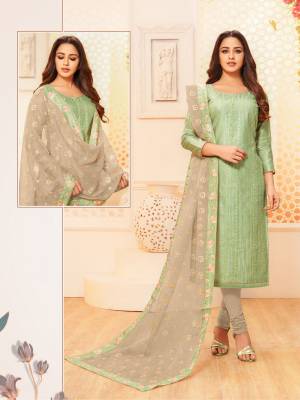 Here Is A Pretty Designer Straight Suit For Your Semi-Casual Wear In Light Green Color Paired With Grey Colored Bottom And Dupatta. Its Top IS Fabricated On Modal Silk Paired With Cotton Bottom And Net Fabricated Dupatta.