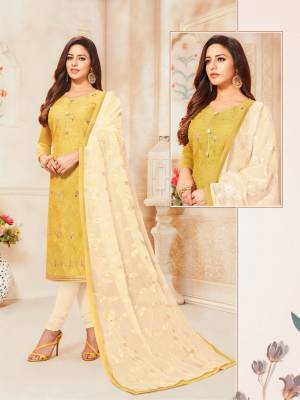 Here Is A Pretty Designer Straight Suit For Your Semi-Casual Wear In Yellow Color Paired With Off-White Colored Bottom And Dupatta. Its Top IS Fabricated On Modal Silk Paired With Cotton Bottom And Chiffon Fabricated Dupatta.