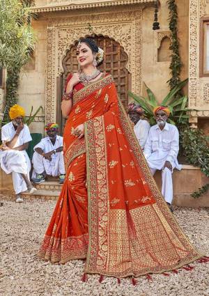 Celebrate This Festive In This Rich And Elegant Looking Silk Based Designer Saree In Orange Color Paired With Red Colored Blouse. This Saree Is Fabricated On Satin Jacquard Silk Paired With Art Silk Fabricated Blouse. Its Rich Fabric And Color Will Earn You Lots Of Compliments From Onlookers.