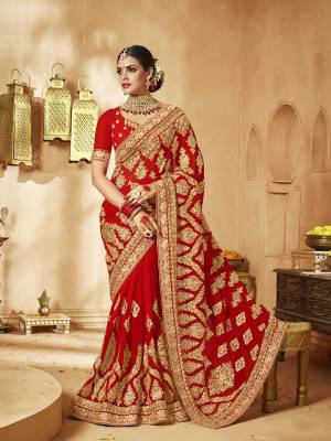 Here Is A Very Attractive Heavy Designer Bridal Saree For The Upcoming Wedding Season In Red Color Paired With Embroidered Red Colored Blouse. It Is Beautified With Heavy Jari Embroidery With Stone Work. Buy This Lovely Bridal Saree Now.
