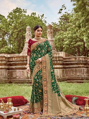 Here Is A Very Pretty Heavy Designer Saree. This Beautiful Green Colored Heavy Embroidered Saree Is Fabricated On Jacquard Silk Paired With An Embroidered Maroon Colored Art Silk Fabricated Blouse. Buy This Pretty Saree Now.