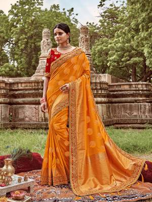 Celebrate This Festive And Wedding Season With This Heavy Designer Saree In Musturd Yellow Color Paired With Contrasting Red Colored Blouse. This Pretty Saree Is Fabricated On Jacquard Silk Paired With Art Silk Fabricated Blouse.