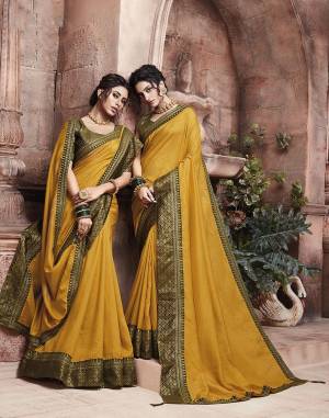 Grab This Pretty Attractive Saree In Musturd Yellow Color Paired With?Contrasting Olive Green Colored Blouse. This Saree Is Fabricated On Soft Art Silk Paired With Brocade Fabricated Blouse. Its Rich Fabric And Color Will Earn You Lots Of Compliments From Onlookers.?