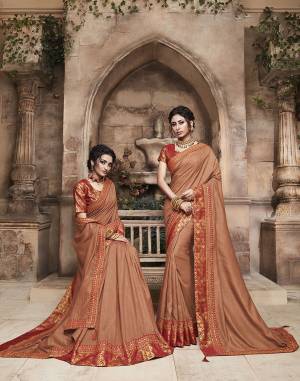 Grab This Pretty Attractive Saree In Brown Color Paired With?Contrasting Red Colored Blouse. This Saree Is Fabricated On Soft Art Silk Paired With Brocade Fabricated Blouse. Its Rich Fabric And Color Will Earn You Lots Of Compliments From Onlookers.?