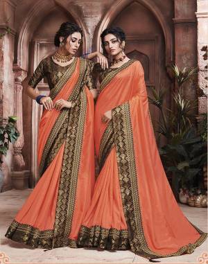 Grab This Pretty Attractive Saree In Orange Color Paired With?Contrasting Brown Colored Blouse. This Saree Is Fabricated On Soft Art Silk Paired With Brocade Fabricated Blouse. Its Rich Fabric And Color Will Earn You Lots Of Compliments From Onlookers.?