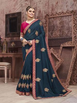 Add This Very Beautiful And Attractive Looking Designer Saree In Navy Blue Color Paired With Contrasting Dark Pink Colored Blouse. This Saree Is Fabricated On Soft Art Silk Paired With Art Silk Fabricated Blouse. It Is Beautified With Embroidered Motifs Giving An Elegant Look To The Saree. 