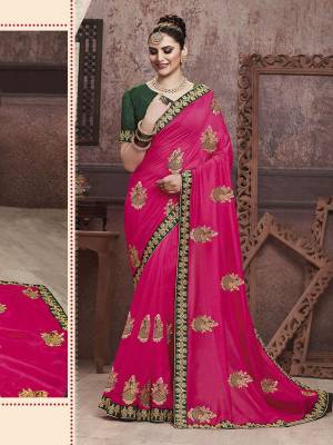 Celebrate This Festive Season With Beauty And Comfort In This Motif Embroidered Yet Elegant Saree In Rani Pink Color Paired With Contrasting Dark Green Colored Blouse. This Saree And Blouse are Silk Based Which Gives A Rich Look To Your Personality. 