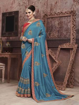Add This Very Beautiful And Attractive Looking Designer Saree In Blue Color Paired With Contrasting Red Colored Blouse. This Saree Is Fabricated On Soft Art Silk Paired With Art Silk Fabricated Blouse. It Is Beautified With Embroidered Motifs Giving An Elegant Look To The Saree. 