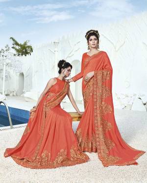 Here Is A Rich Silk Based Designer Saree In Orange Color Paired With Orange Colored Blouse. This Pretty Saree Is Beautified With Detailed Embroidery Giving An Attractive Look. 