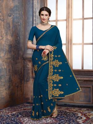For Your Semi-Casual Wear, Grab This Pretty Saree In Blue Color. This Saree And Blouse Are Georgette Based With A Minimal Of Embroidery Work With Jari And Tone To Tone Resham.