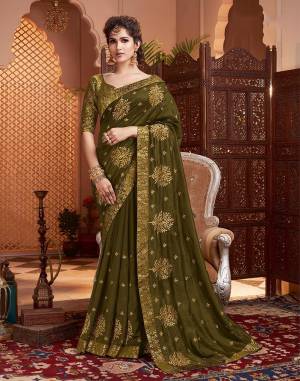 Grab This Pretty Attractive Saree In Olive Green Color. This Saree Is?Fabricated On Soft Art Silk Paired With Brocade Fabricated Blouse. It Has Attractive Jari Embroidered Motifs Highlited With Stone Work. Its Rich Fabric And Color Will Earn You Lots Of Compliments From Onlookers.