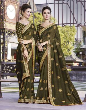 Grab This Pretty Attractive Saree In Olive Green Color. This Saree Is Fabricated On Art Silk Paired With Jacquard Silk Fabricated Blouse. It Has Attractive Jari Embroidered Motifs With Detailed Weaved Broad Border. Its Rich Fabric And Color Will Earn You Lots Of Compliments From Onlookers.