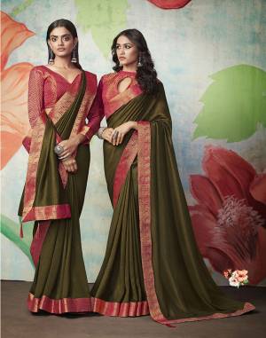 Celebrate This Festive Season With Beauty And Comfort Wearing This Simple And Elegant Looking Designer Saree In Olive Green Color Paired With Contrasting Pink Colored Blouse. This Saree IS Silk Based Paired With Jacquard Silk Fabricated Blouse.