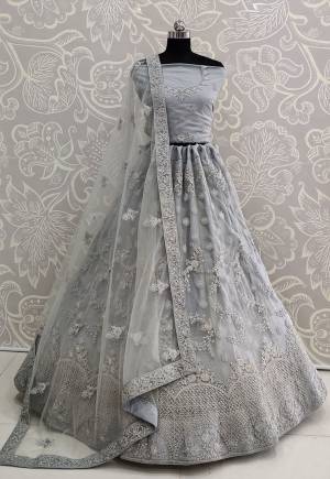 Here Is A Very Pretty Heavy Designer Lehenga Choli For The Bridesmaid In This Lovely Grey Color. This Detailed Embroidered Lehenga Choli And Dupatta Are Fabricated On Net Which Is Light Weight, Durable And Gives A Pretty Look The Personality. Buy This Pretty Piece Now.