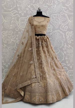 Here Is A Very Pretty Heavy Designer Lehenga Choli For The Bridesmaid In This Lovely Beige Color. This Detailed Embroidered Lehenga Choli And Dupatta Are Fabricated On Net Which Is Light Weight, Durable And Gives A Pretty Look The Personality. Buy This Pretty Piece Now.