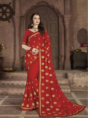 Celebrate This Festive Season With Beauty and Comfort In This Lovely Designer Saree In Red color. This Saree And Blouse Are Satin Chiffon Based Beautified With Jari Embroidered Motifs. 