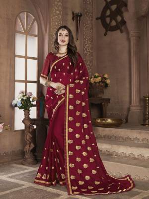 Celebrate This Festive Season With Beauty and Comfort In This Lovely Designer Saree In Maroon color. This Saree And Blouse Are Satin Chiffon Based Beautified With Jari Embroidered Motifs. 