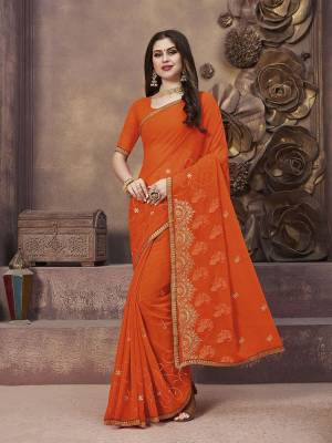 Celebrate This Festive Season With Beauty And Comfort Wearing This Pretty Elegant Designer Saree In Orange Color. This Saree And Blouse Are Fabricated On Georgette Beautified With Jari Embroidery And Thread Work.