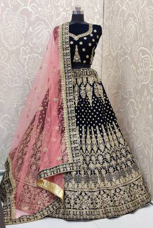 Look Pretty In This Trending Color For Bridal Wear In Navy Blue?Color Paired With Contrasting Pink Colored Dupatta. This Very Beautiful Heavy Designer Lehenga Choli Is Fabricated on Velvet Paired With Net Fabricated Dupatta. Buy Now. Its Attractive Embroidery And Color Will Definitlely Earn You Lots Of Compliments From Onlookers.