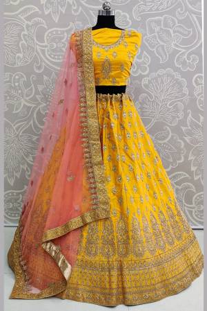 Look Pretty In This Very Beautiful And Heavy Designer Lehenga Choli In Yellow Color Paired With Contrasting Baby Pink Colored Dupatta. Its Heavy Embroidered Blouse And Lehenga Are Fabricated On Satin Silk Paired With Net Fabricated Dupatta. Buy Now.