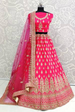 Catch All The Limelight At The Next Wedding You Attend Wearing This Heavy Designer Lehenga Choli In All Over Rani Pink Color. This Lehenga Choli Is Satin Silk Based Paired With Net Fabricated Dupatta.