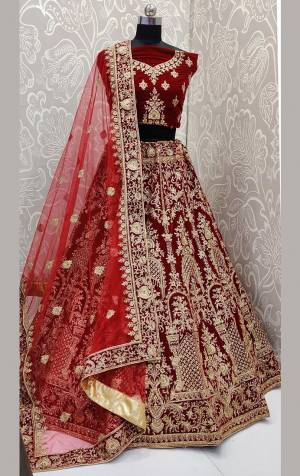 Get Ready For Your D-Day With This Heavy Designer Lehenga Choli In Maroon Color. This Heavy Embroidered Lehenga Choli Is Fabricated On Velvet Paired With Net Fabricated Dupatta. It Is Beautified With Heavy Jari Embroidery And Stone Work. Buy This Bridal Lehenga Now.
