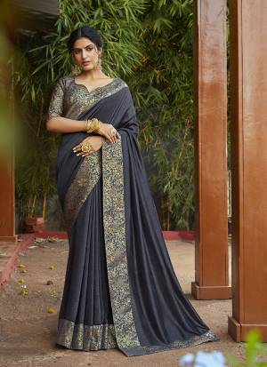 Add Some Rich And Elegant looking Simple Yet Designer Saree In Dark Grey Color. This Saree Is Fabricated On Art Silk Paired with Jacquard Silk Fabricated Blouse. Buy Now.