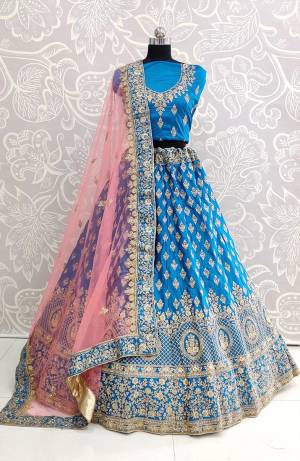Look Pretty In This Very Beautiful And Heavy Designer Lehenga Choli In Blue Color Paired With Contrasting Baby Pink Colored Dupatta. Its Heavy Embroidered Blouse And Lehenga Are Fabricated On Satin Silk Paired With Net Fabricated Dupatta. Buy Now