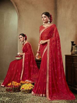 Adorn The Pretty Angelic Look Wearing This Designer Saree In Red Color. This Saree IS Fabricated On Chiffon Paired With Brocade Fabricated Blouse. Buy Now.