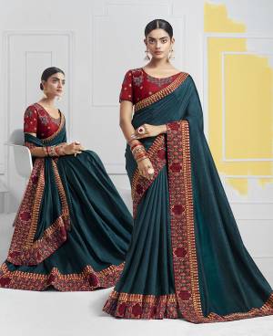 Look Beautiful In Attractive Designer Saree In Prussian Blue Color Paired With Contrasting Maroon Colored Blouse. This Saree And Blouse Are Silk Based Beautified With Detailed Attractuve Embroidery. Buy This Saree Now.