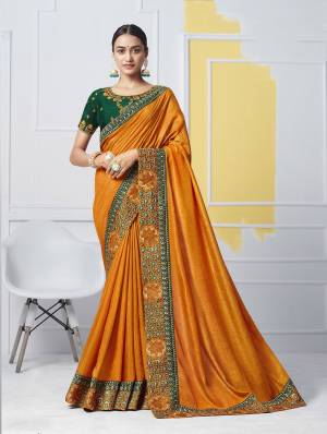 Add This Pretty Designer Saree In Musturd Yellow Color Paired With Contrasting Dark Green Colored Blouse. This Saree Is Fabricated On Soft Art Silk Paired With Art Silk Fabricated Blouse. Buy This Saree Now. 