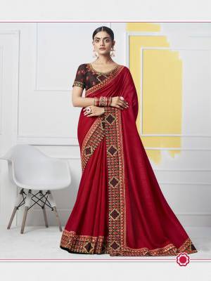 Look Beautiful In Attractive Designer Saree In Red Color Paired With Contrasting Maroon Colored Blouse. This Saree And Blouse Are Silk Based Beautified With Detailed Attractuve Embroidery. Buy This Saree Now.