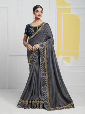 Add This Pretty Designer Saree In Dark Grey Color Paired With Contrasting Navy Blue Colored Blouse. This Saree Is Fabricated On Soft Art Silk Paired With Art Silk Fabricated Blouse. Buy This Saree Now. 